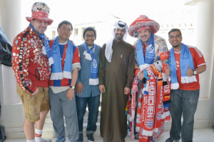 Vijay Bharadwaj (far-right) and the Super Fans, pictured alongside Nasser Al-Khater, Assistant Secretary General of the SC